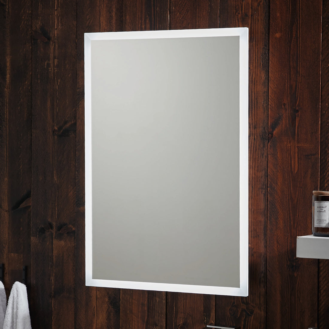 Woman in a white robe using a smartphone in front of a mirror with music notes above it on a wooden wall.