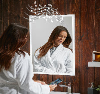 Woman in a white robe using a smartphone in front of a mirror with music notes above it on a wooden wall.