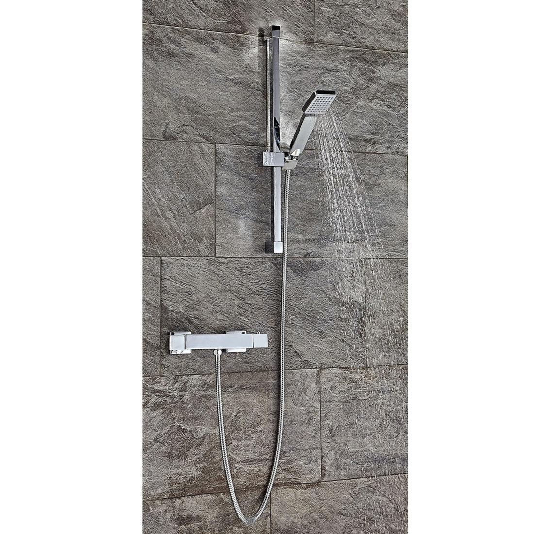Chrome shower set with handheld shower and control handle mounted on a tiled wall.