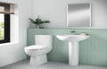 Bathroom with a white sink and toilet against a green tiled wall.