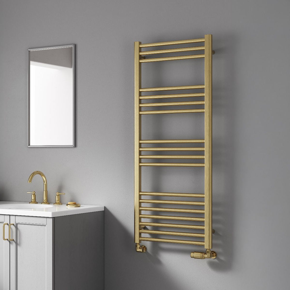 Gold towel radiator in a bathroom setting with a mirror and sink.