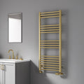 Gold towel radiator in a bathroom setting with a mirror and sink.