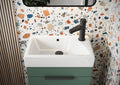 Bathroom vanity with white sink and green base against a terrazzo-patterned wall.