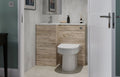 Bathroom interior with wooden vanity and toilet, framed pictures on the wall.