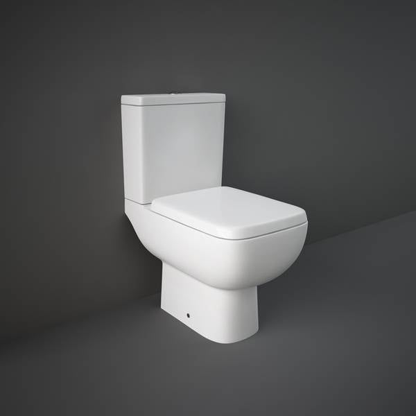 White toilet against a dark gray wall