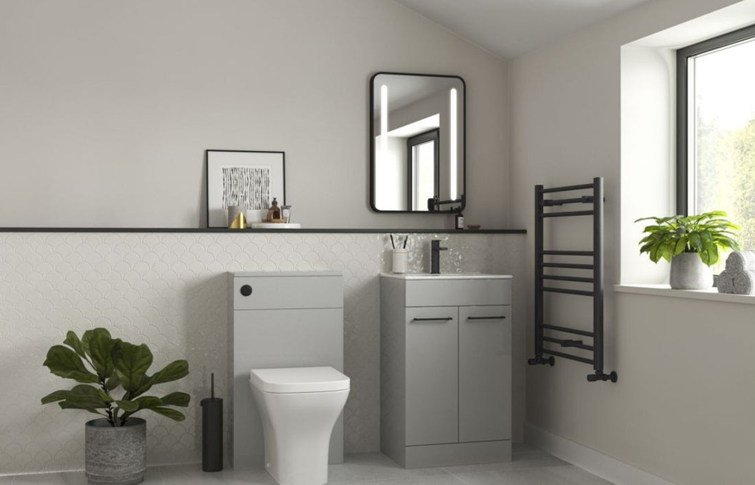 Bathroom interior with gray vanity, toilet, and towel rack.