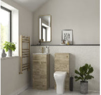 Bathroom with wooden vanity, toilet, and decorative elements.